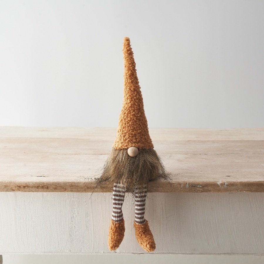 An adorable sitting gonk decoration with a sherpa hat and booties in a warming caramel colour. 