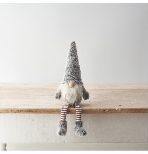 A cute gonk decoration featuring faux fur details and striped legs with a stylish grey colour scheme. 