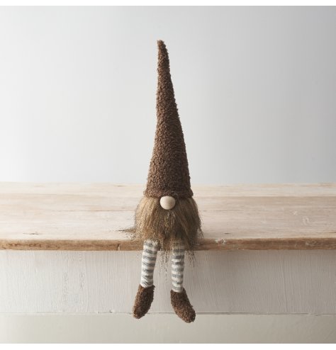 A charming gonk decoration featuring sherpa details and dangly striped legs in neutral brown tones. 