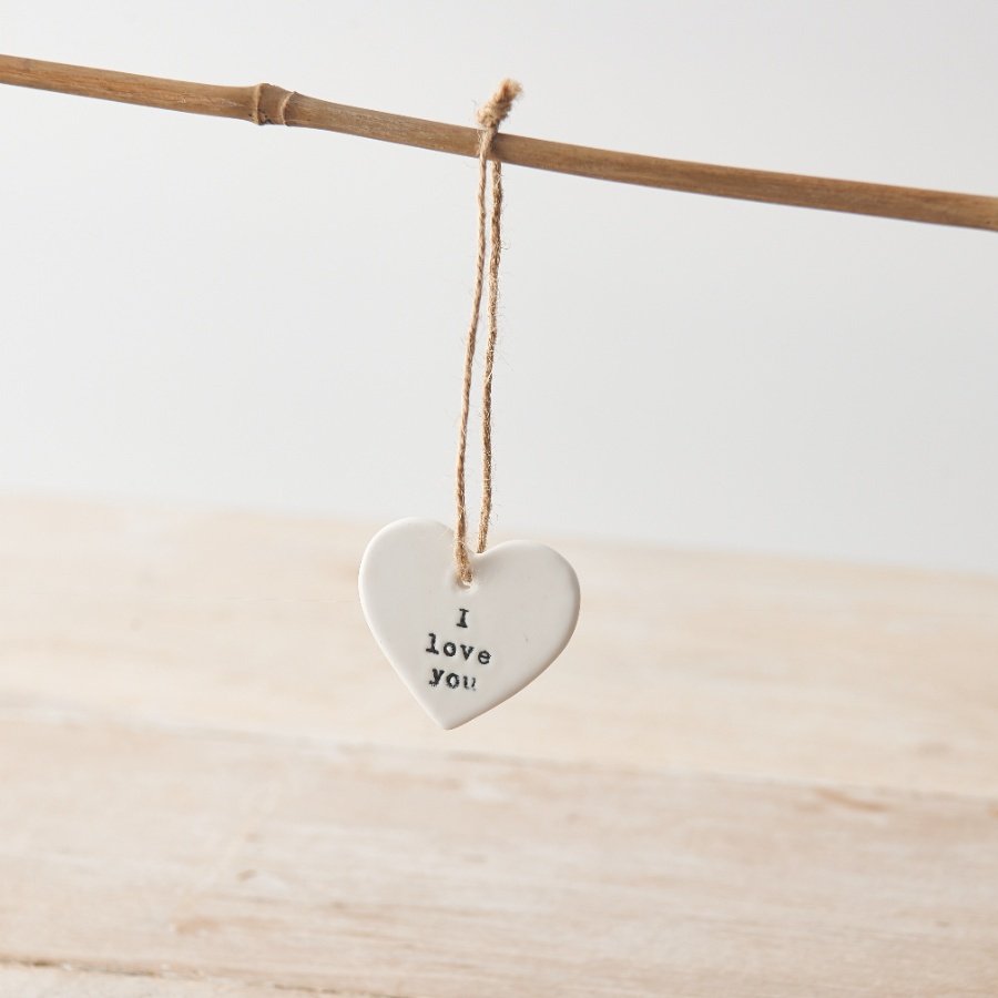 A chic porcelain heart shaped hanger with a 'i love you' stamp. Complete with jute string.