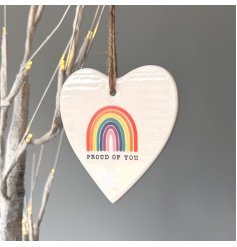 A chic heart shaped hanging sign with a rainbow design.