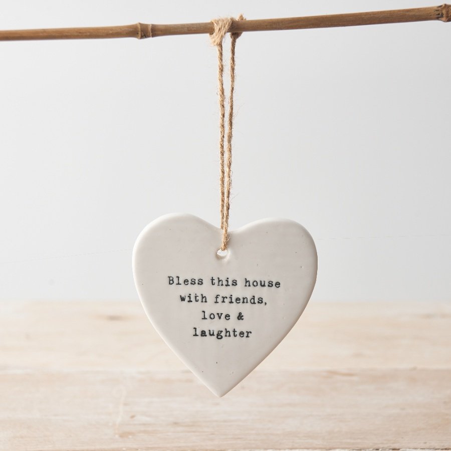 A charming heart shaped plaque made from porcelain. With a rustic jute string hanger and stamped home slogan. 