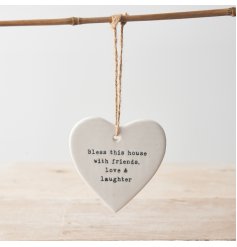 A chic porcelain heart with a stamped home slogan. Complete with a jute string hanger. 