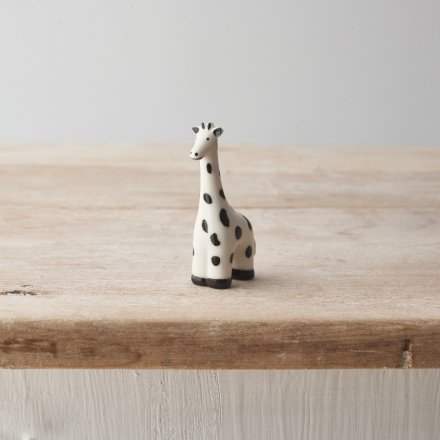 A decorative porcelain giraffe with a super cute spotted monochrome design. 