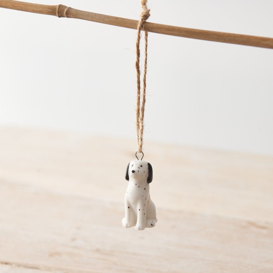 A small porcelain dog hanging decoration featuring a Dalmatian design with monochrome colour scheme and twine hanger. 