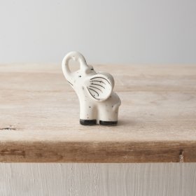 A small porcelain elephant decoration with a delicate speckled finish. 