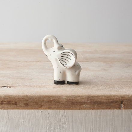 A mini elephant porcelain decoration with black speckled print and detailing.