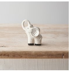 A mini elephant porcelain decoration with black speckled print and detailing.