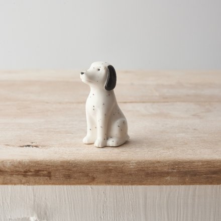 A small porcelain dog ornament featuring a Dalmatian design with monochrome colour scheme. 
