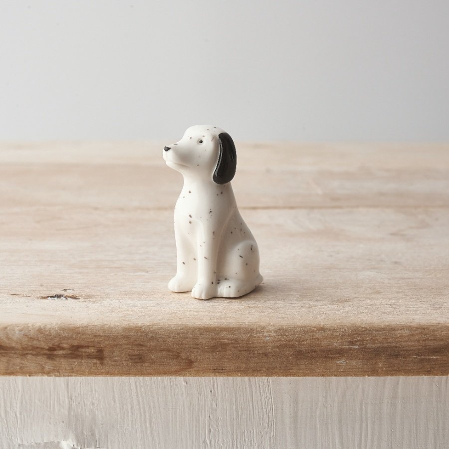 A small porcelain Dalmatian ornament with monochrome design and speckled pattern. 