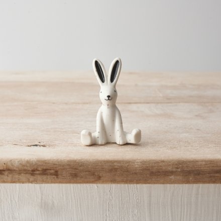 A mini porcelain ornament with a cute rabbit design and speckled pattern. 