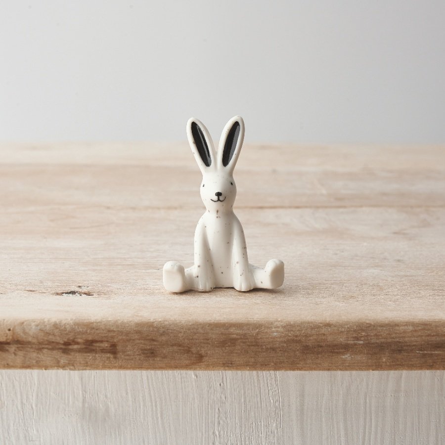 A small porcelain rabbit decoration with a monochrome design and delicate speckled pattern.