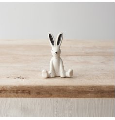 A small porcelain rabbit ornament featuring a monochrome design with speckled pattern. 
