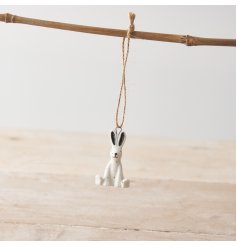 A mini porcelain hanging decoration with a cute rabbit design and speckled pattern. 