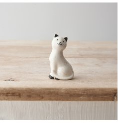 A porcelain cat ornament with a delicate speckled pattern and cute smiling face! 