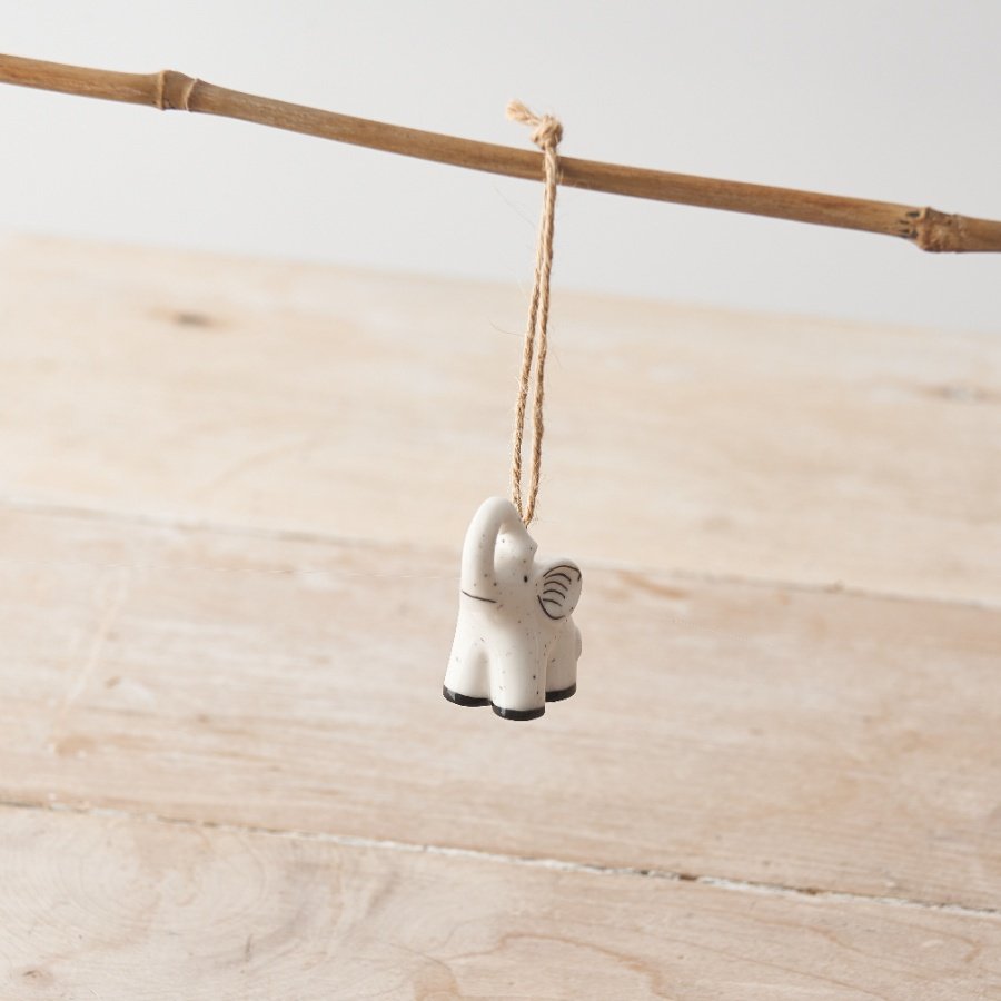 A dainty porcelain elephant decoration hanging decoration with delicate polka dot details. 