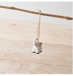 A small porcelain elephant hanging decoration with a monochrome colour palette and polka dot details. 