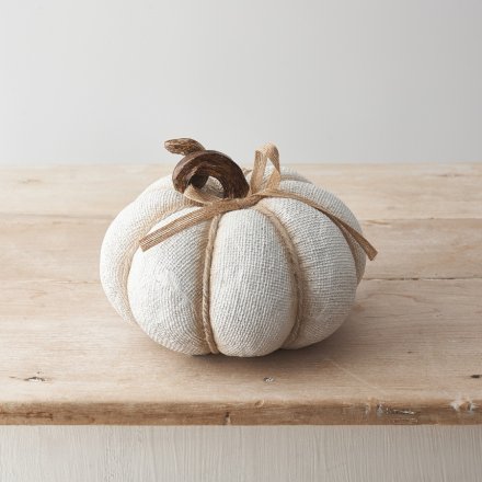 A textured fabric effect pumpkin decoration with ribbon detailing and spiral stalk design in neutral colour tones. 