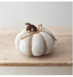 A textured fabric effect pumpkin decoration with ribbon detailing and spiral stalk design. 