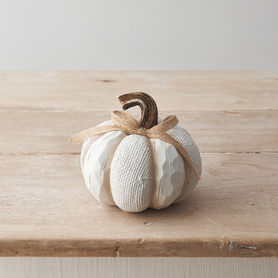 A cute pumpkin decoration made from polyresin with textured surface design, contrasting stalk and finished with a bow. 