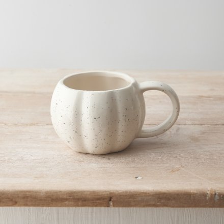 A stylish pumpkin shaped mug with a delicately speckled pattern design. 