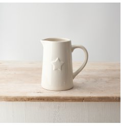 A stylish white ceramic jug with a 3D star print detail.