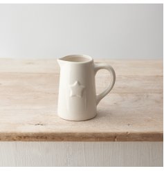 A stylish white ceramic jug with a 3D star print detail.