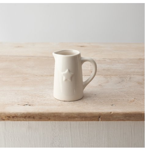 A small ceramic jug with a simple and stylish design and embossed star detail. 