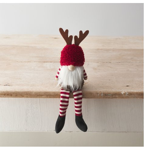 A cute gonk decoration with fluffy hat, red and white striped pattern and antler design. 