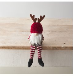 An adorable gonk decoration with red and white striped pattern, fluffy hat and antler design. 