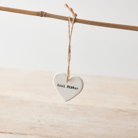 A white ceramic heart hanging decoration with "soul sister" message. 