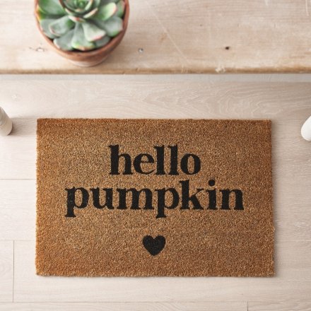 A coir doormat with simple "hello pumpkin" text design with a small heart motif. 