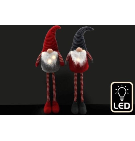 A mix of 2 red and grey fabric gonk decorations. A nordic style favourite with tall telescopic legs and a light up beard