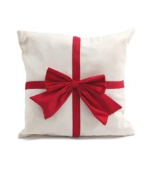 Snuggle up this season with this beautiful and soft cream cushion with a large red traditional bow.