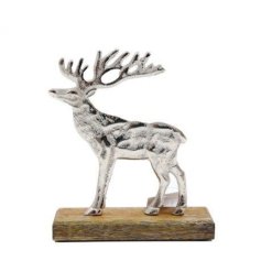 A rustic silver stag ornament with a hammered finish and mango wood base.