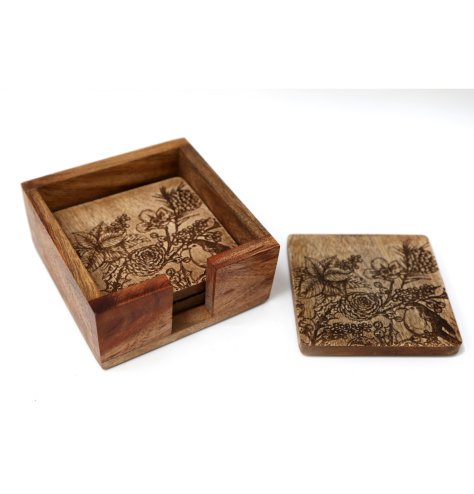 A set of 4 natural wooden coasters with a carved robin and seasonal floral design. 