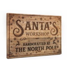 Santa's Workshop. Handcrafted at the North Pole. A natural wooden board with a seasonal laser cut design.