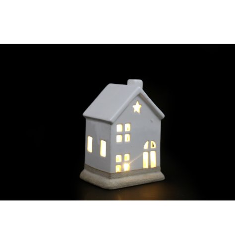 A stylish porcelain LED house decoration with contrasting base and star cut out detail. 