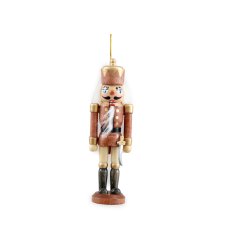 A wooden nutcracker decoration with gold detailing. 