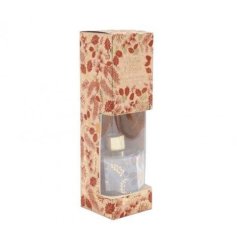 A stylish reed diffuser with a mistletoe and berries fragrance and decorated with festive foliage. 