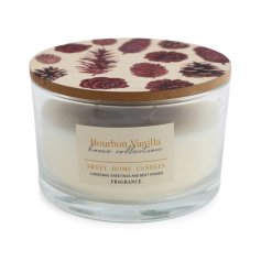 A stylish scented wax candle in glass jar with wooden lid decorated with pinecone illustrations. 
