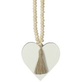 A hanging wooden heart with natural wooden beads and tassel.