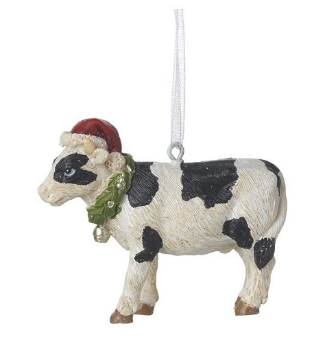 A rustic Christmas cow tree decoration, featuring a holly wreath around the cows neck and a festive Santa hat.