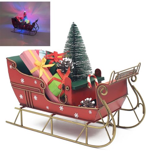 A metal sleigh with gifts and a LED lit Christmas tree.