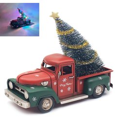 A rustic metal truck with an LED lit Christmas tree.