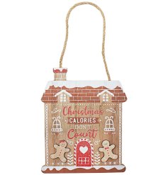 Hanging wooden plaque in the theme of a gingerbread house and with a cheeky joke.