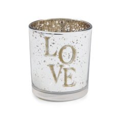 A glass tea light holder with a distressed gold finish and "love" text. 