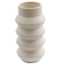A chic ribbed vessel for display in the home. A stylish vase for flowers and foliage.