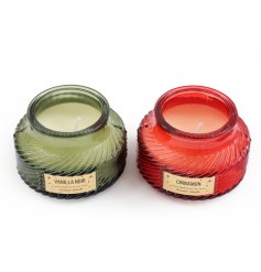 An assortment of two glass candle pots, each filled with a luxurious scented candle in vanilla and cinnamon fragrances. 