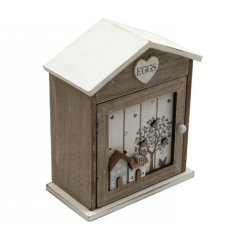 A wooden egg house with 3D hearts and houses design with chicken and tree silhouette details. 